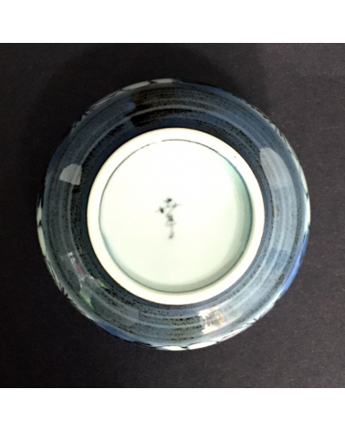 Bowl for tea with flowers of cherry in blue and black