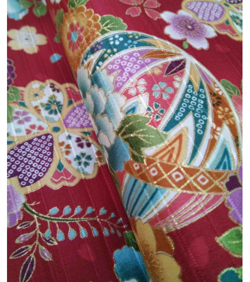 Satin fabric with temari over carmine red background