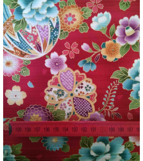 Satin fabric with temari over carmine red background