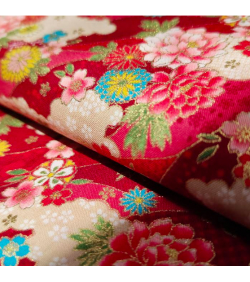 Japanese fabric. Flowers and clouds over red.