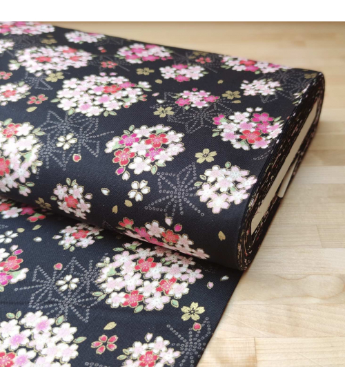 Japanese fabric with sakuras and asanoha on a black background.