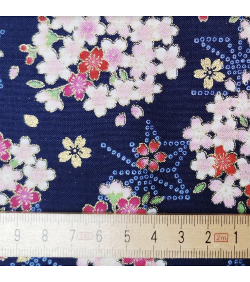 Japanese fabric with sakuras and asanoha on a blue background.