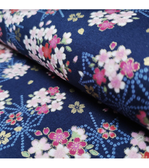 Japanese fabric with sakuras and asanoha on a blue background.