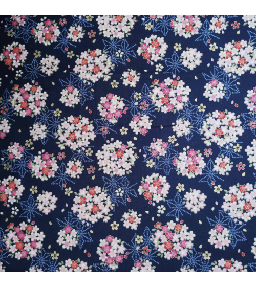 Japanese fabric with sakuras and asanoha on a blue background.
