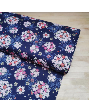 Japanese fabric with sakuras and asanoha on a blue background.