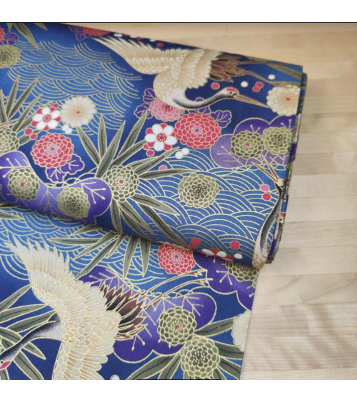 Japanese cotton fabric of cranes in blue with golden details.