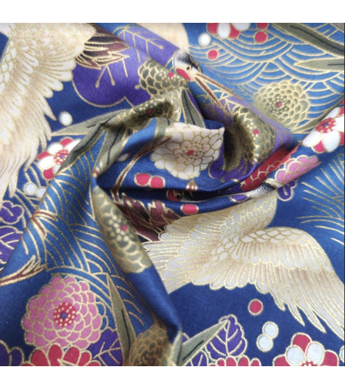 Japanese cotton fabric of cranes in blue with golden details.