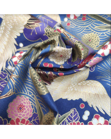 Japanese cotton fabric of cranes in blue with golden details.