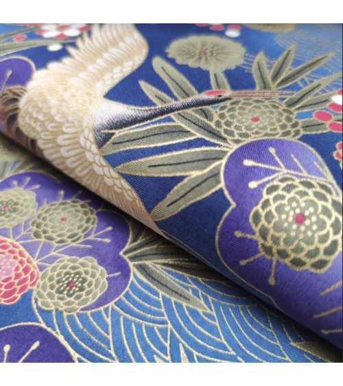 Japanese cotton fabric of cranes in blue with golden details.