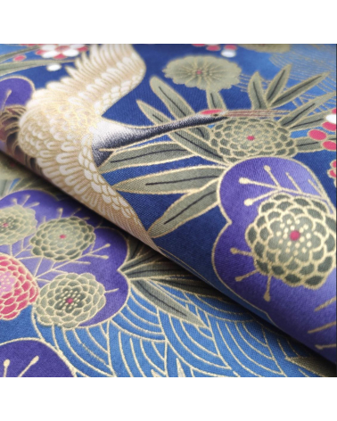 Japanese cotton fabric of cranes in blue with golden details.