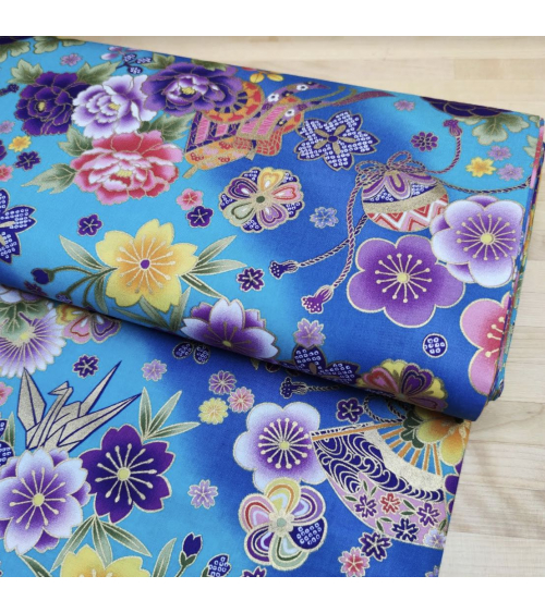 Japanese fabric origami cranes in turquoise with golden details.