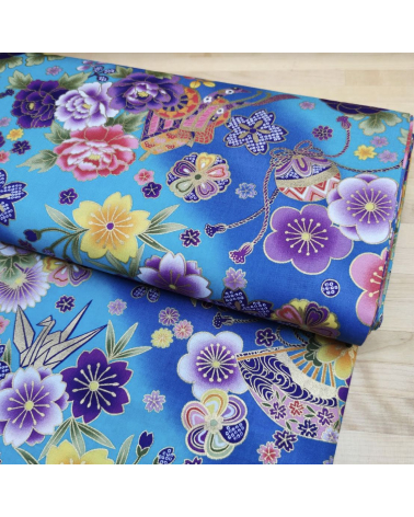 Japanese fabric origami cranes in turquoise with golden details.