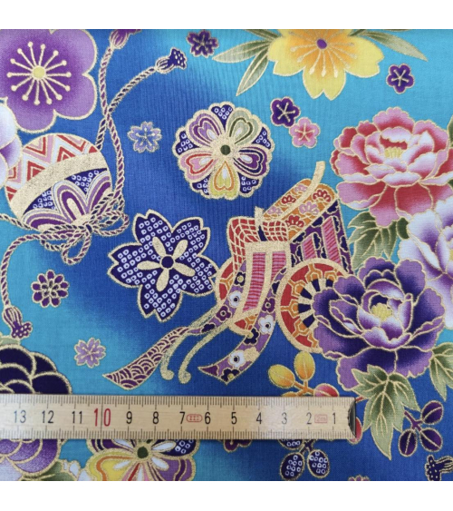 Japanese fabric origami cranes in turquoise with golden details.