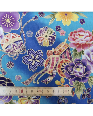 Japanese fabric origami cranes in turquoise with golden details.