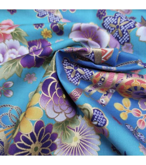 Japanese fabric origami cranes in turquoise with golden details.