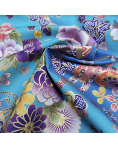 Japanese fabric origami cranes in turquoise with golden details.