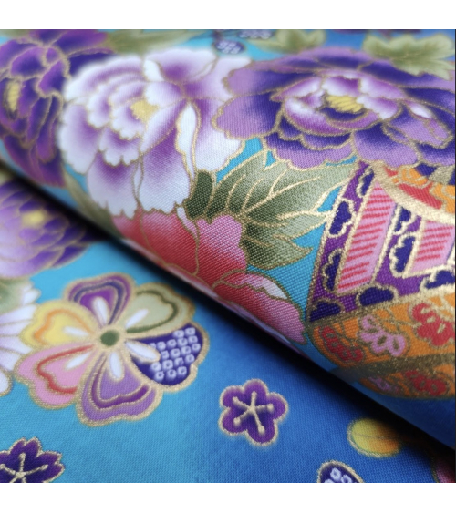 Japanese fabric origami cranes in turquoise with golden details.