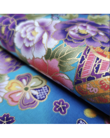 Japanese fabric origami cranes in turquoise with golden details.