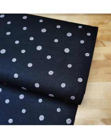 Japanese cotton-linen fabric with irregular polka dots over black background