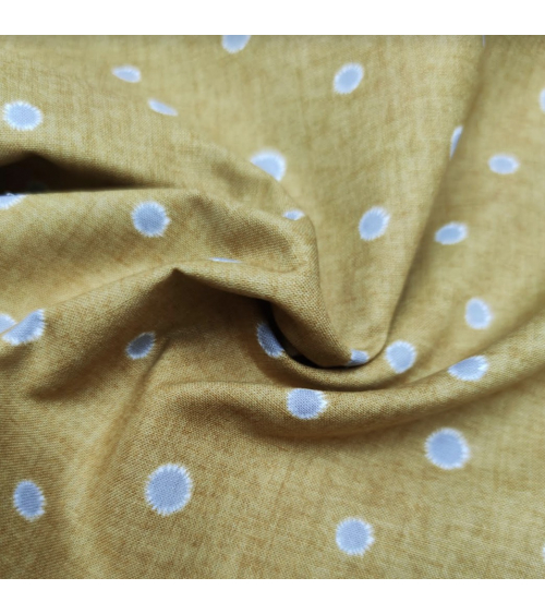 Japanese cotton-linen fabric with irregular polka dots over mustard background