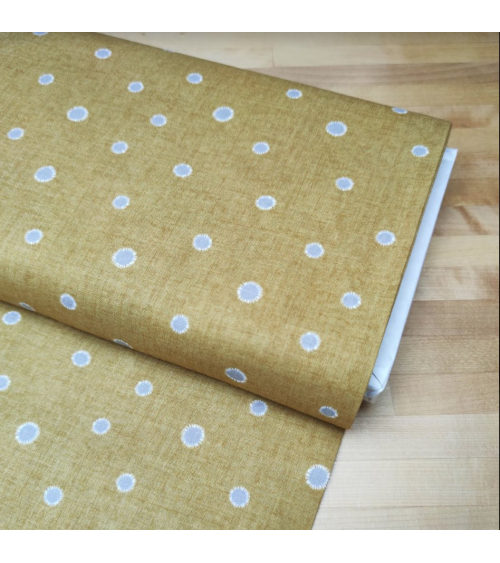 Japanese cotton-linen fabric with irregular polka dots over mustard background