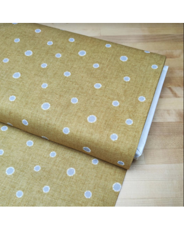 Japanese cotton-linen fabric with irregular polka dots over mustard background