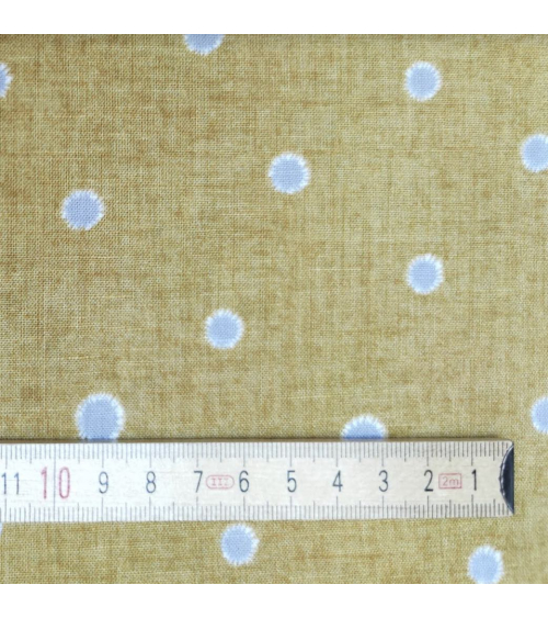 Japanese cotton-linen fabric with irregular polka dots over mustard background