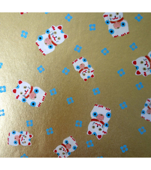 Papel japonés chiyogami maneki neko sobre fondo dorado