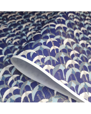 Papel japonés Chiyogami con grullas al vuelo sobre fondo azul.