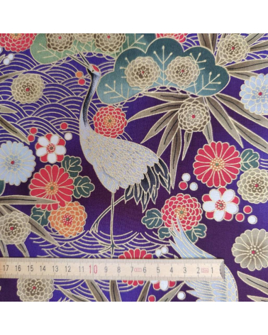 Japanese cotton fabric of cranes in violet with golden details.