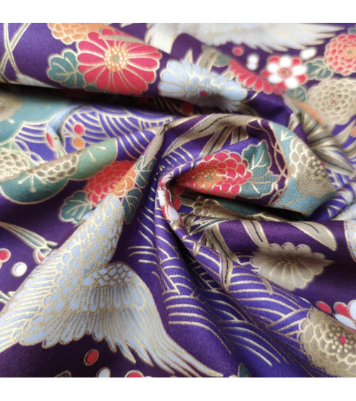 Japanese cotton fabric of cranes in violet with golden details.