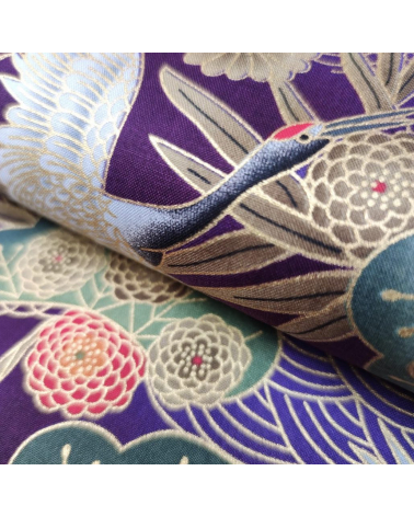 Japanese cotton fabric of cranes in violet with golden details.