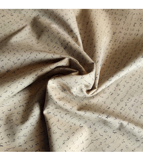 Japanese fabric. Hiragana over sand.