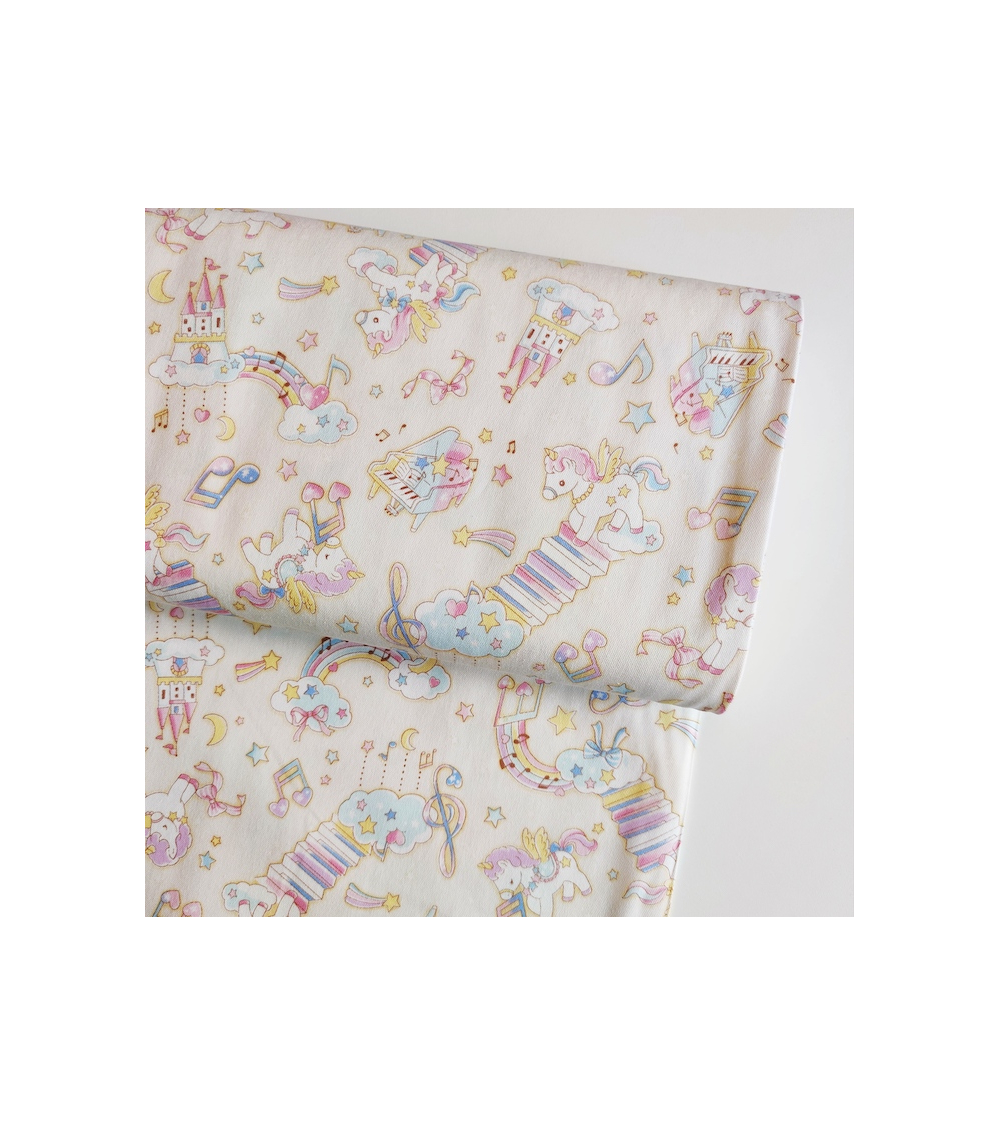 Tela japonesa Oxford fino "Unicornios musicales" con fondo vainilla.