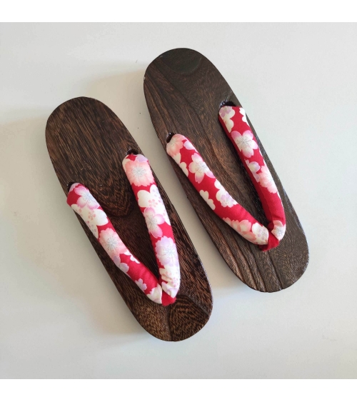 Geta sandals with cherry blossom (sakura) on a red background.