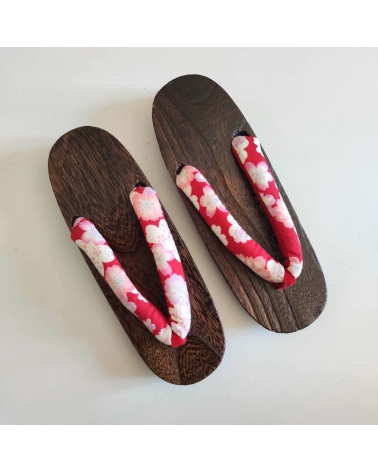 Geta sandals with cherry blossom (sakura) on a red background.