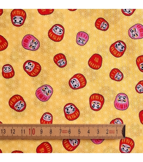 Japanese 100% cotton fabric "Darumas and asanoha" in yellow.