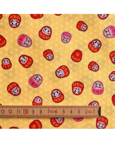 Japanese 100% cotton fabric "Darumas and asanoha" in yellow.