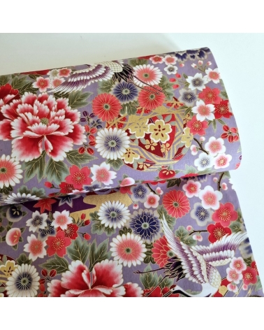 Japanese fabric. Multicolored cranes (tsuru) and flowers (hana) over lilac background, outlined in gold.