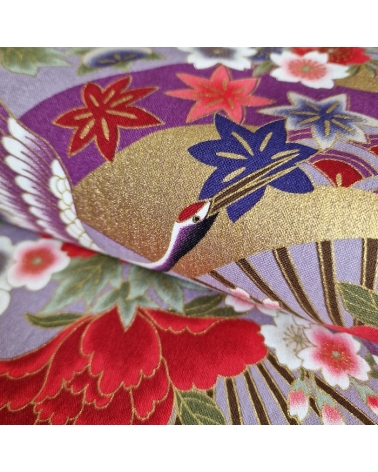 Japanese fabric. Multicolored cranes (tsuru) and flowers (hana) over lilac background, outlined in gold.