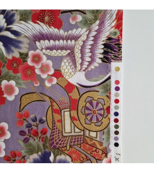 Japanese fabric. Multicolored cranes (tsuru) and flowers (hana) over lilac background, outlined in gold.