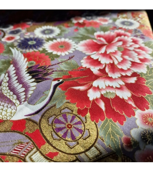 Japanese fabric. Multicolored cranes (tsuru) and flowers (hana) over lilac background, outlined in gold.
