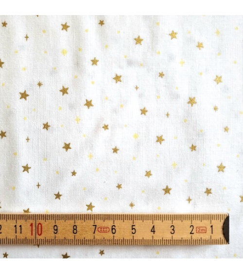 Tela japonesa de estrellitas doradas sobre fondo blanco