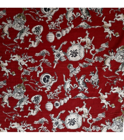 Tela japonesa "Choju-giga" con fondo rojo guinda, en dobby de algodón 100%.