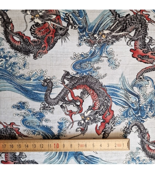 Japanese dobby fabric with small dragons and waves in bluish white.