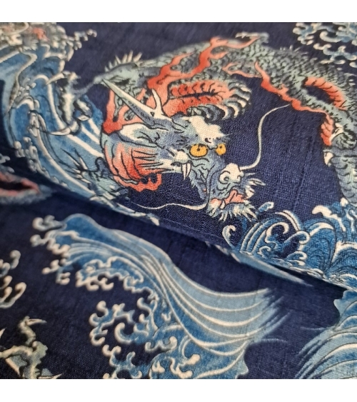 Japanese dobby fabric with small dragons and waves in blue.