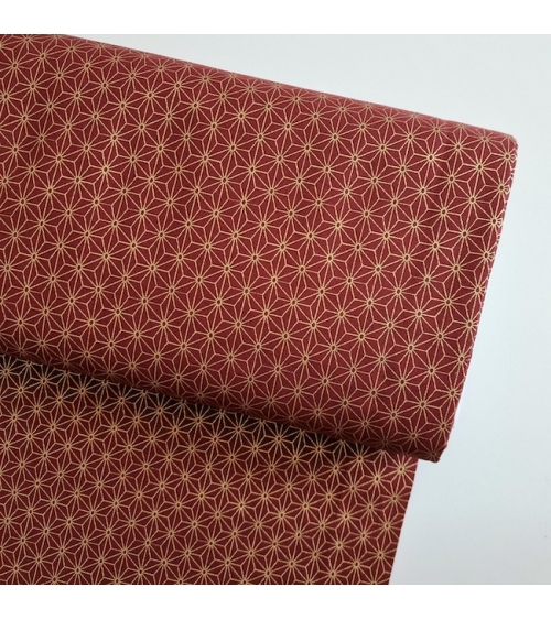 Japanese cotton fabric with golden asanohas over maroon