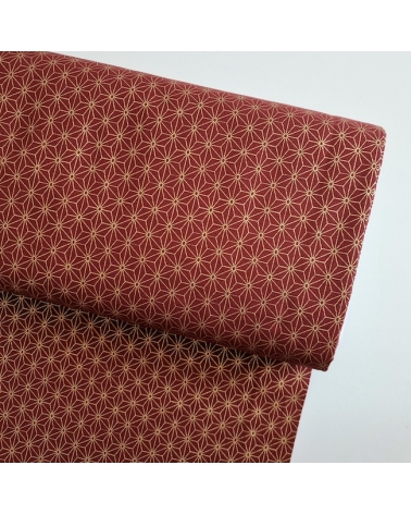 Japanese cotton fabric with golden asanohas over maroon