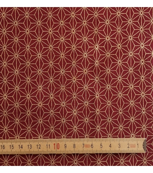 Japanese cotton fabric with golden asanohas over maroon