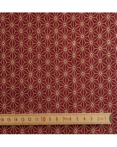 Japanese cotton fabric with golden asanohas over maroon